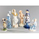 A group of six 19th century ceramic figurines depicting battledore and shuttlecock, including an