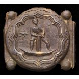 A Victorian cricket buckle with a registered design mark for 1863, portraying a wicket keeper up