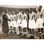 A press photograph of King George VI shaking hands with the Huddersfield Town team at the 1938 F.