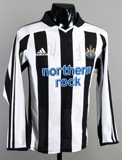 A Newcastle United replica jersey signed by club legends Sir Bobby Robson and Alan Shearer,