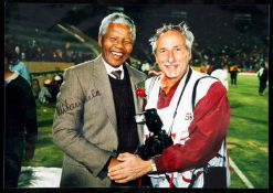 A signed photograph of President Nelson Mandela at the 1995 Rugby World Cup,
7 by 10in.