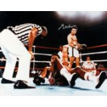 A colour photograph double-signed by Muhammad Ali and George Foreman,
an impressive 16 by 20in.