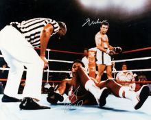 A colour photograph double-signed by Muhammad Ali and George Foreman,
an impressive 16 by 20in.