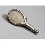 A Continental metalware matchstick striker in the form of a very detailed miniature tennis racket,