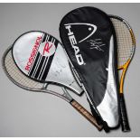 Two tennis racquets with the head covers signed by the champions players Andre Agassi and Mats