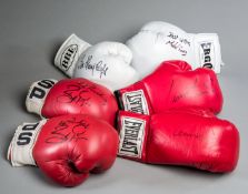 A group of six boxing gloves signed by British & Irish champions,