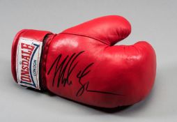 A Mike Tyson signed boxing glove,