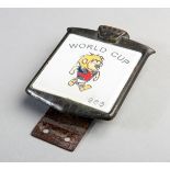 A 1966 World Cup car grill badge,
depicting the mascot World Cup Willie and inscribed WORLD CUP,