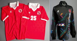 Two red Switzerland international jerseys circa 1994,
the first a short-sleeved No.