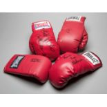 Four signed boxing gloves,
i) Larry Holmes, red right-hand Everlast 
ii) Nigel Benn,