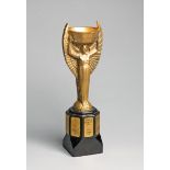 A cast brass replica of the Jules Rimet Trophy circa 1970,
a well modelled, heavy replica,