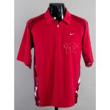 A red Nike half-zip top signed by the tennis champion Roger Federer,