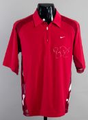 A red Nike half-zip top signed by the tennis champion Roger Federer,