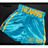 Fight worn boxing trunks signed by Thomas "Hit Man" Hearns,
turquoise & gold silk inscribed HEARNS,