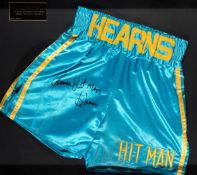 Fight worn boxing trunks signed by Thomas "Hit Man" Hearns,
turquoise & gold silk inscribed HEARNS,