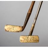 Two brass headed putters,
one centre-shafted, with steel shaft,