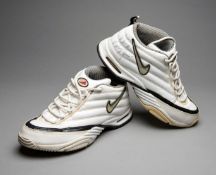 A pair of vintage white Nike Zm Air tennis shoes signed by Andre Agassi,