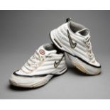 A pair of vintage white Nike Zm Air tennis shoes signed by Andre Agassi,