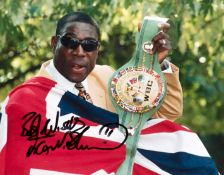 A group of four signed photographs of the British boxer Frank Bruno,
all framed, various sizes,