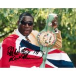 A group of four signed photographs of the British boxer Frank Bruno,
all framed, various sizes,
