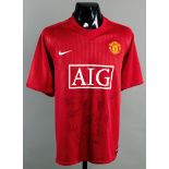 A red Manchester United replica jersey signed by the 2008 Champions League Final winners,