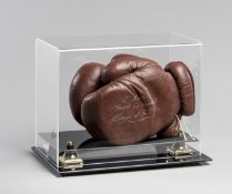 A pair of vintage boxing gloves signed by Ricky Hatton,