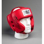 A boxing head guard signed by Mike Tyson,
red everlast signed in black market pen,