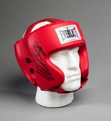 A boxing head guard signed by Mike Tyson,
red everlast signed in black market pen,