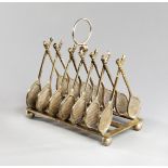 An electroplated toast rack with dividers designed as tennis racquets circa 1900,