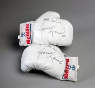 A pair of boxing gloves signed by Lennox Lewis,