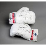 A pair of boxing gloves signed by Lennox Lewis,