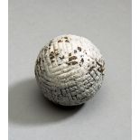 A hand hammered gutty golf ball circa 1865,