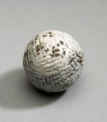 A hand hammered gutty golf ball circa 1865,