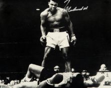 A Muhammad Ali signed photograph,
b&w 7 1/4 by 9 1/4 image of Ali standing over Sonny Liston,