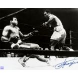 A Joe Frazier signed b&w photograph,
a 16 by 20in, portraying Frazier knocking down Muhammad Ali,
