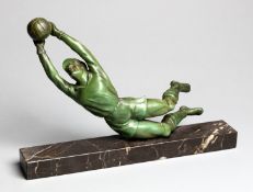 A spelter figure of a diving goalkeeper,
with green patina, set on a marble plinth, 22 by 35cm.