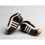 A miniature pair of early Adidas football boots thought to be salesman's samples during the