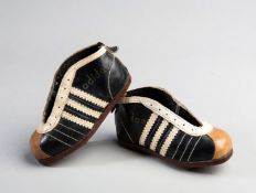 A miniature pair of early Adidas footbal