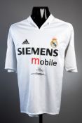 A Real Madrid replica shirt signed by Zinedine Zidane,