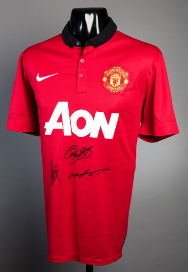 A Manchester United replica shirt signed by Wayne Rooney, Paul Scholes & Ryan Giggs,