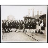 An original b&w press photograph of a group of United States women's athletes at the quayside