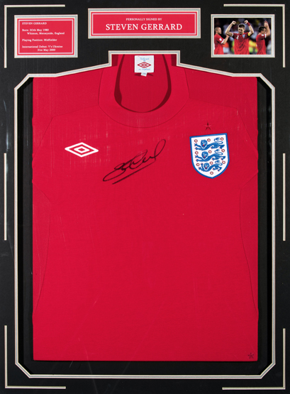 A Steven Gerrard signed red England replica jersey,
signature in black marker pen, mounted beneath,