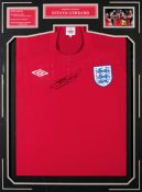 A Steven Gerrard signed red England replica jersey,
signature in black marker pen, mounted beneath,