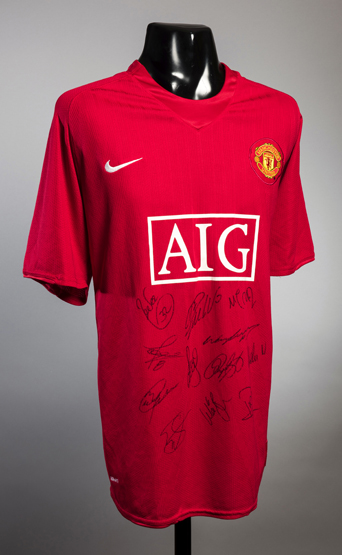 A red replica Manchester United jersey signed by members of the 2008 Champions League winning squad,