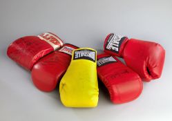 A collection of eight boxing gloves.