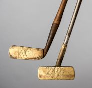 Two brass headed putters,
one centre-shafted, with steel shaft,