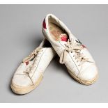 A pair of Jimmy Connors's tennis shoes,
a pair of white Super Pros with red & blue trim,