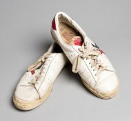 A pair of Jimmy Connors's tennis shoes,
a pair of white Super Pros with red & blue trim,