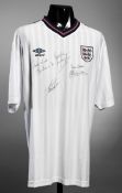 A white England replica jersey signed by four prolific goalscorers Bobby Charlton, Gary Lineker,