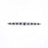 White gold sapphire bar brooch, tests 9 ct.